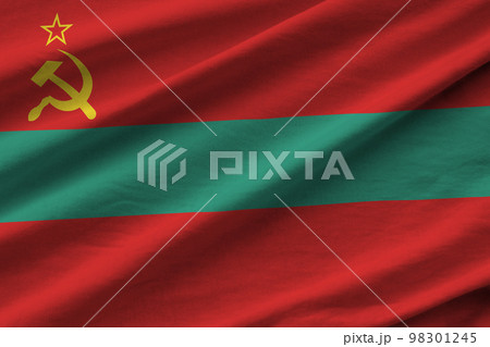 Transnistria flag with big folds waving close up under the studio light indoors. The official symbols and colors in banner 98301245