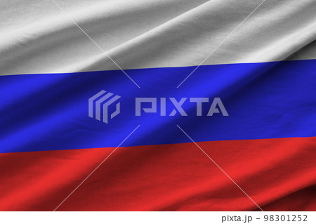 Russia flag with big folds waving close up under the studio light indoors. The official symbols and colors in banner Russia flag with big folds waving close up under the studio light indoors. The official symbols and colors in banner 98301252
