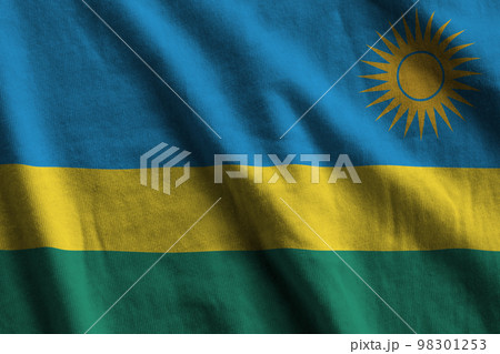 Rwanda flag with big folds waving close up under the studio light indoors. The official symbols and colors in banner 98301253