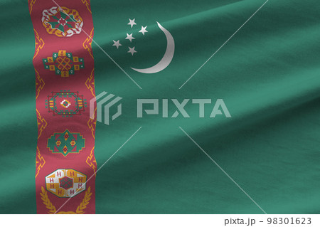 Turkmenistan flag with big folds waving close up under the studio light indoors. The official symbols and colors in banner 98301623