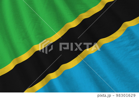 Tanzania flag with big folds waving close up under the studio light indoors. The official symbols and colors in banner 98301629