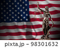 United States of America flag with statue of lady justice and judicial scales in dark room. Concept of judgement and punishment 98301632
