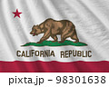 California US state flag with big folds waving close up under the studio light indoors. The official symbols and colors in banner 98301638