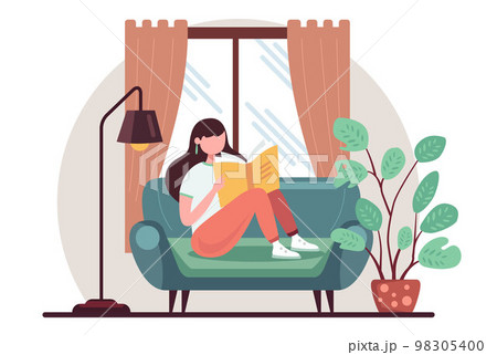 girl reads a book on the sofa. studying at home. girl reads a book on the sofa. studying at home. 98305400
