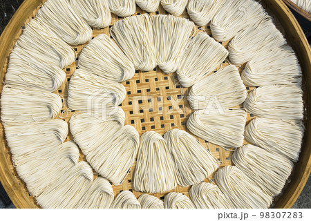 Close-up of traditional handmade noodle-making drying outdoors in Guanmiao, Tainan, Taiwan. 98307283