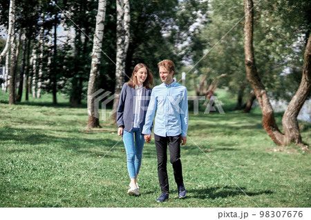 happy couple in love walking along a path in the park. 98307676