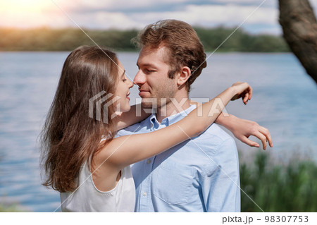 young couple kisses during a country walk . young couple kisses during a country walk . 98307753
