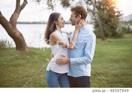 man and a woman in love tenderly looking at each other . 98307849