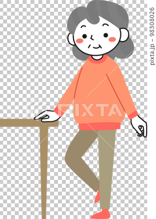 机につかまって片足立ちの運動をするシニア女性 98308026