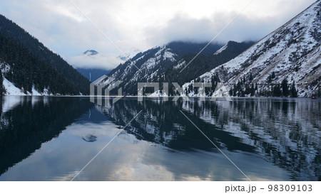 Kolsai mountain lake in the winter forest. Kolsai mountain lake in the winter forest. 98309103