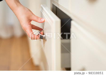 Close-up on woman's hand opens kitchen table drawer 98310051