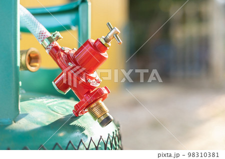 Metal valve for close or open on new green cooking gas tank. safety from gas using concept Metal valve for close or open on new green cooking gas tank. safety from gas using concept 98310381