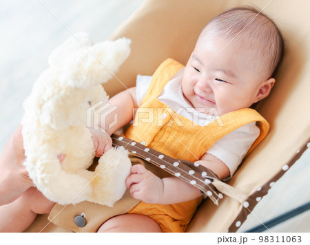 バウンサーの赤ちゃん ぬいぐるみであやす バウンサーの赤ちゃん ぬいぐるみであやす 98311063