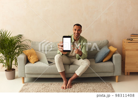 Man Showing Smartphone At Home. Guy Demonstrating Mobile With Blank White Screen 98311408