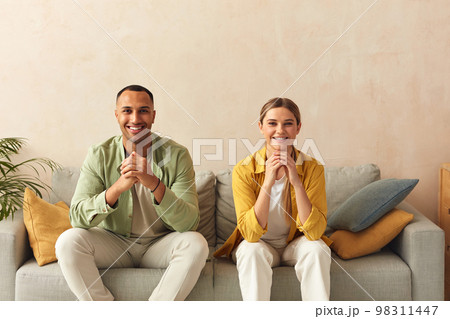 Happy Couple Watching TV At Home. Loving People Resting On Sofa Happy Couple Watching TV At Home. Loving People Resting On Sofa 98311447