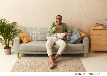 Emotional Man Watching Movie. Multiracial Guy Eating Popcorn, Feeling Scary 98311469