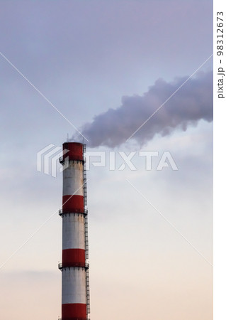 Gray smoke from the plant chimney at sunset 98312673