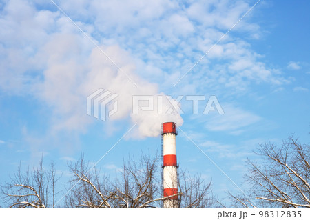 Gray smoke from the plant chimney in blue sky 98312835