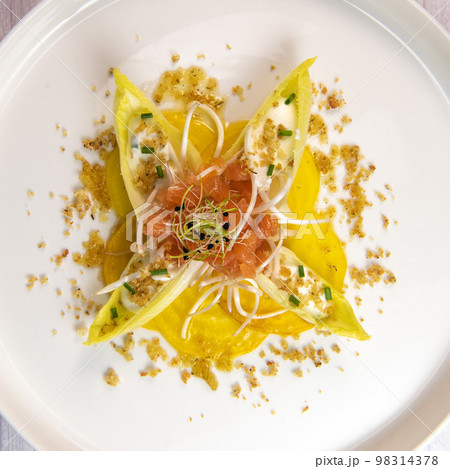 Recipe for salmon gravlax salad, endives filled with creame fresh, chives, yellow chioggia beetroot 98314378