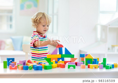 Kids toys. Child building tower of toy blocks. Kids toys. Child building tower of toy blocks. 98316509