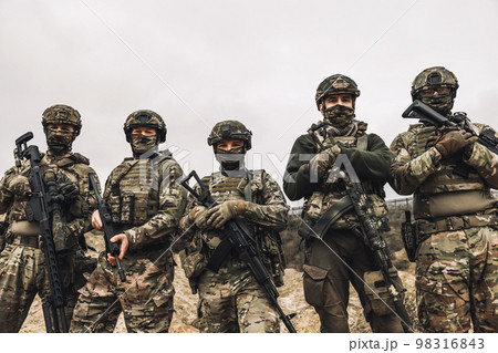 Group of soldiers in camouflage with rifles in hands 98316843