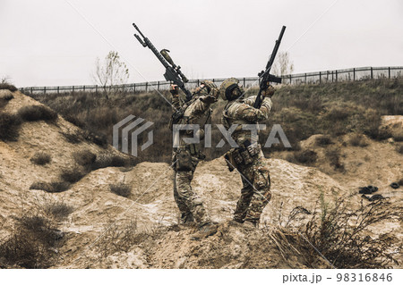Two soldiers with their rifles shooting 98316846
