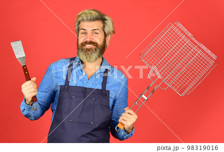 Bbq party. Culinary concept. summer weekend. happy hipster hold cooking utensils for barbecue. bearded man chef. Tools for roasting meat outdoors. Picnic and barbecue. ready for barbecue party Bbq party. Culinary concept. summer weekend. happy hipster hold cooking utensils for barbecue. bearded man chef. Tools for roasting meat outdoors. Picnic and barbecue. ready for barbecue party 98319016