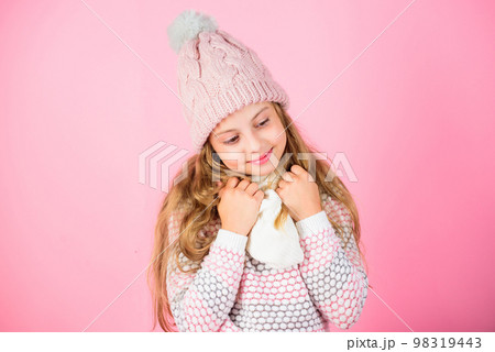 Kid smiling wear knitted accessory. Kid girl wear cute knitted fashionable hat and scarf accessory. Winter fashion accessory. Winter accessory concept. Girl long hair dreamy mood pink background Kid smiling wear knitted accessory. Kid girl wear cute knitted fashionable hat and scarf accessory. Winter fashion accessory. Winter accessory concept. Girl long hair dreamy mood pink background 98319443