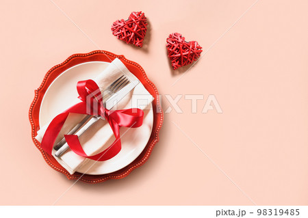 Valentines day table place setting with red rose, two hearts. 98319485