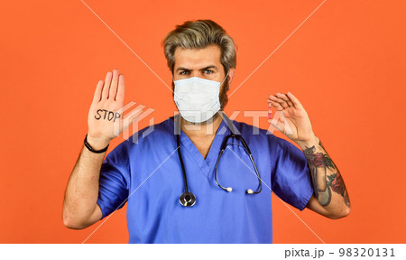Open palm stop gesture. Epidemic threshold. Man in medical lab. Protective mask. Stop epidemic. Virus concept. Danger zone. Epidemic infection. Critical number or density of susceptible hosts 98320131