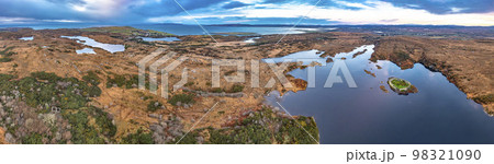 Aerial view of Lough Doon between Portnoo and Ardara which is famous for the medieval fort - County Donegal - Ireland. Aerial view of Lough Doon between Portnoo and Ardara which is famous for the medieval fort - County Donegal - Ireland. 98321090