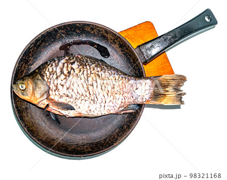 Fish crucian carp in a pan on a cutting board. Fish crucian carp in a pan on a cutting board. 98321168
