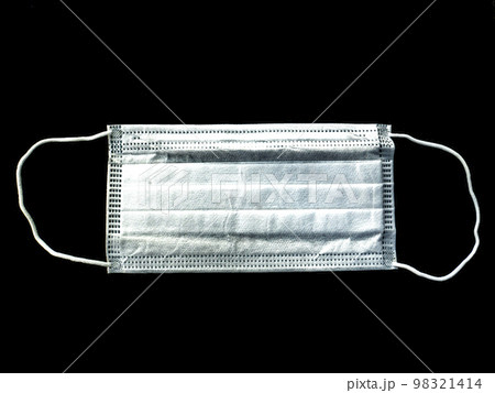 White medical face mask on a black background. White medical face mask on a black background. 98321414