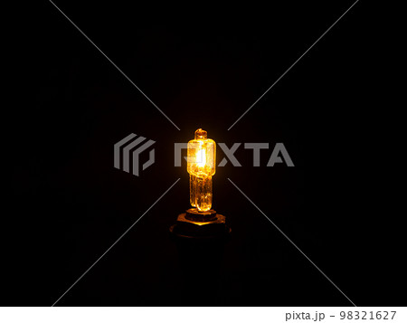 Glow of a halogen bulb in the dark. Glow of a halogen bulb in the dark. 98321627