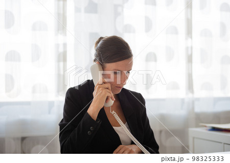 Young secretary talking on a phone Young secretary talking on a phone 98325333