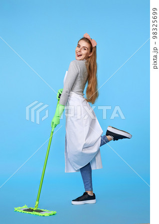 woman in rubber gloves and cleaner apron washing floor with mop 98325699