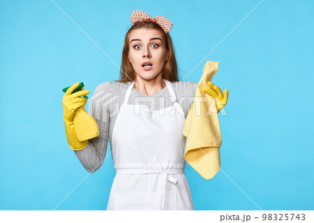woman in gloves and cleaner apron with cleaning rag and detergent sprayer woman in gloves and cleaner apron with cleaning rag and detergent sprayer 98325743