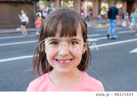 Beautiful little girl eats ice-cream in the summer 98325834