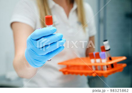 Doctor taking test tube with blue liquid, closeup. Laboratory analysis 98325862