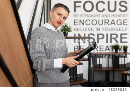 Business woman insurance agent leather folder for documents on office background 98326016