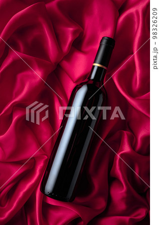 Bottle of red wine on a satin background. 98326209