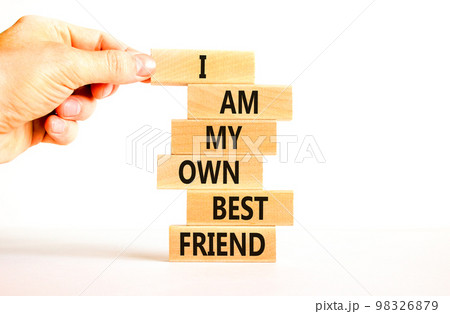 I am my own best friend symbol. Concept words I am my own best friend on wooden blocks on a beautiful white table white background. Businessman hand. Business i am my own best friend concept. 98326879