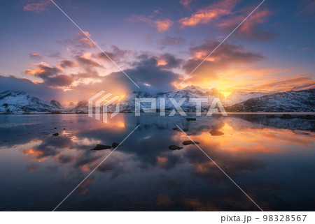 Sea coast, beautiful snowy mountains and colorful sky with clouds Sea coast, beautiful snowy mountains and colorful sky with clouds 98328567