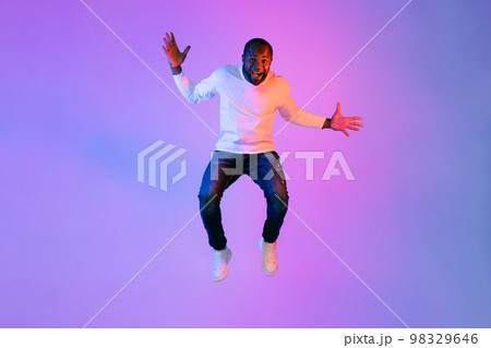 Thrilled emotional black man showing excitement on studio background 98329646