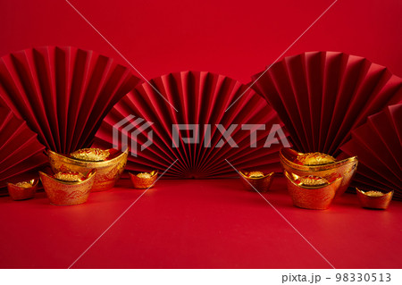 Chinese New Year product display background with ingot and paper fan. Translation: Let ten thousand wishes come true. 98330513