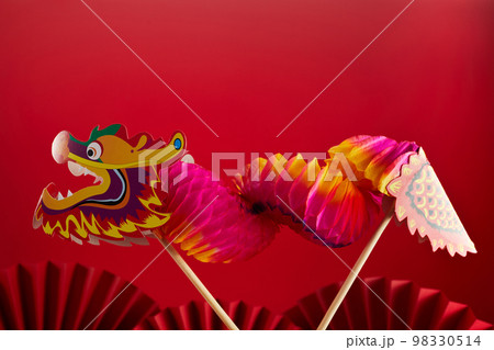 Chinese lion dance for Chinese new year with red fan in the background 98330514
