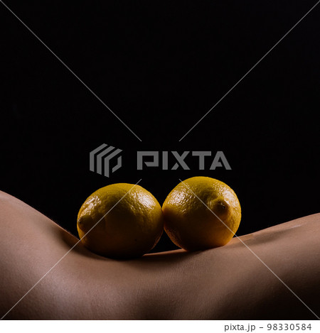 Lemon, natural vitamin c help skin whitening. Naked woman lying on her back with fruit located 98330584