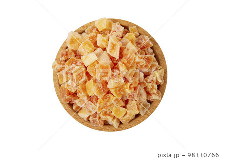 diced candied papaya  in wooden bowl isolated on white background. nutrition. food ingredient. 98330766