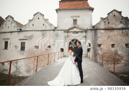Wedding couple holding hands, groom and bride together on wedding day 98330956