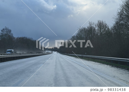 Wet highway against a dramatic sky on a stormy day Wet highway against a dramatic sky on a stormy day 98331438